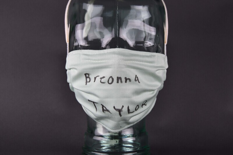 Covid mask of light green fabric. Hand-made. Machine-stitched. “Breonna TAYLOR” handwritten in black felt-tip marker at center anterior.   

Worn by Organizer Joyce Levingston during the 2020 George Floyd Protests in Waterloo, Cedar Falls, and the surrounding area.  Levingston herself organized (with others) the May 29 march from Veterans Memorial Hall to Lincoln Park in Waterloo.  Waterloo Courier photos depict Levingston wearing the mask at the June 6 vigil at Overman Park, Cedar Falls.  Mask also worn at the June 20 march from Clay St. to Overman Park in Cedar Falls.